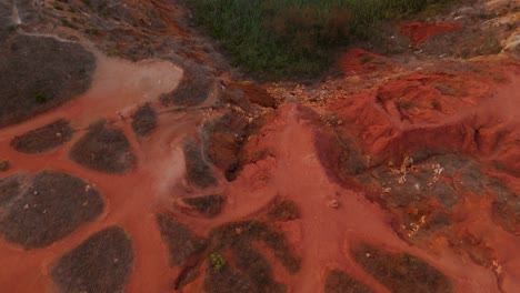 otranto, puglia, italy - the vivid red and orange hues and the scenic beauty of the bauxite cave - drone flying forward