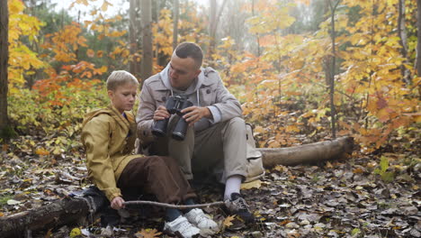 Father-and-son-sitting-at-the-forest