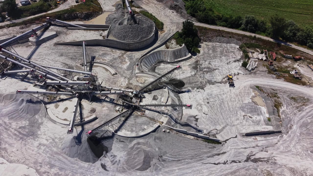 Construction site shows machinery working on a gravel extraction project