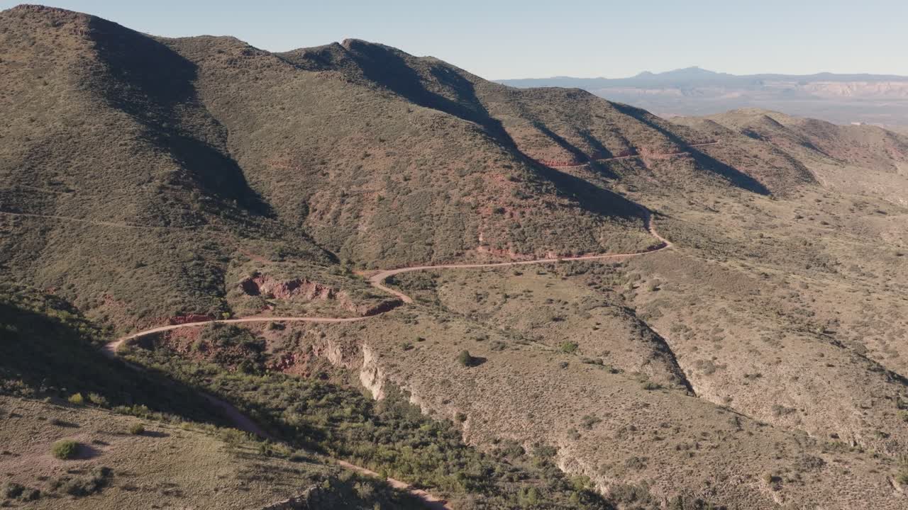 Aerial Drone Flight Following a Winding Mountain Road Through a Desert Canyon Near Jerome Arizona