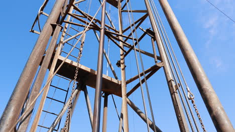 machines, mechanisms and appliances for the production of oil. low angle view on the tower at drilling site.