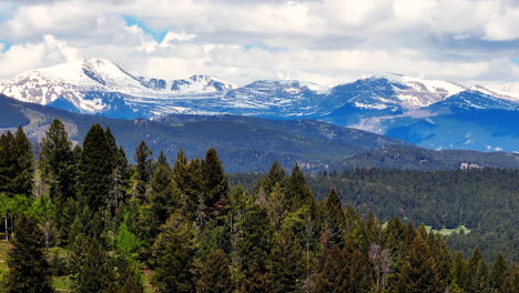 colorado cinematic aerial drone rocky mountains layers denver continental divide mount evans 14ers parallax zoom forest snow on peaks spring summer cloudy thunderstorm lush green evergreen aspen right