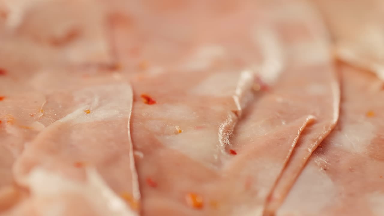 Ham italian mordatella, man Slices Of Traditional Italian antipasti mortadella sausage on a wooden cutting board, close up macro of chicken or turkey jamon, fat breakfast dish.