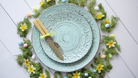 Easter-table-setting-with-flowers-and-eggs--Empty-decorative-ceramic-plates