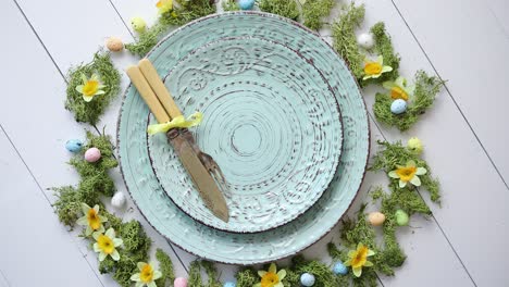 easter table setting with flowers and eggs  empty decorative ceramic plates