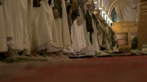 standing people praying and prostration close up to the camera