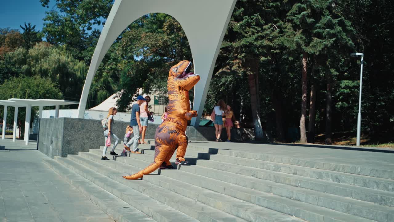 Dinosaur walking in town. Tyrannosaurus rex costume walking on city streets