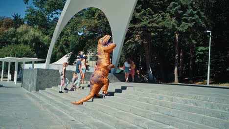 dinosaur walking in town. tyrannosaurus rex costume walking on city streets