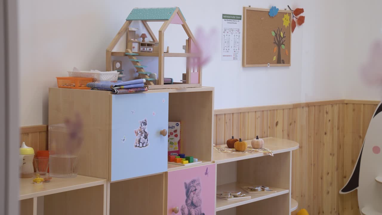 Children's playroom furnishing a dollhouse, various toys, and educational displays for early childhood in daycare