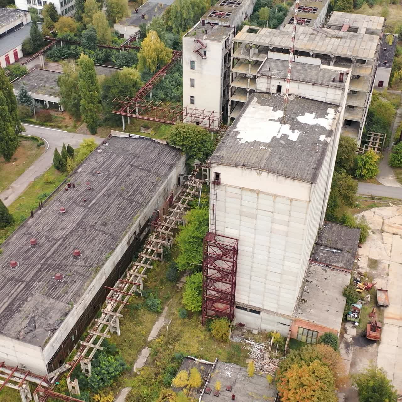 Empty factory caused by the world crisis. Abandoned buildings of industrial plant. Old brick buildings and warehouses. Camera rising