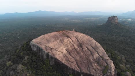 cinematic erial lateral flight of pidurangala and sigiriya rock, one of the best places to visit in sri lanka. shot in 4k.