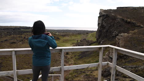 a young woman at a lookout takes a