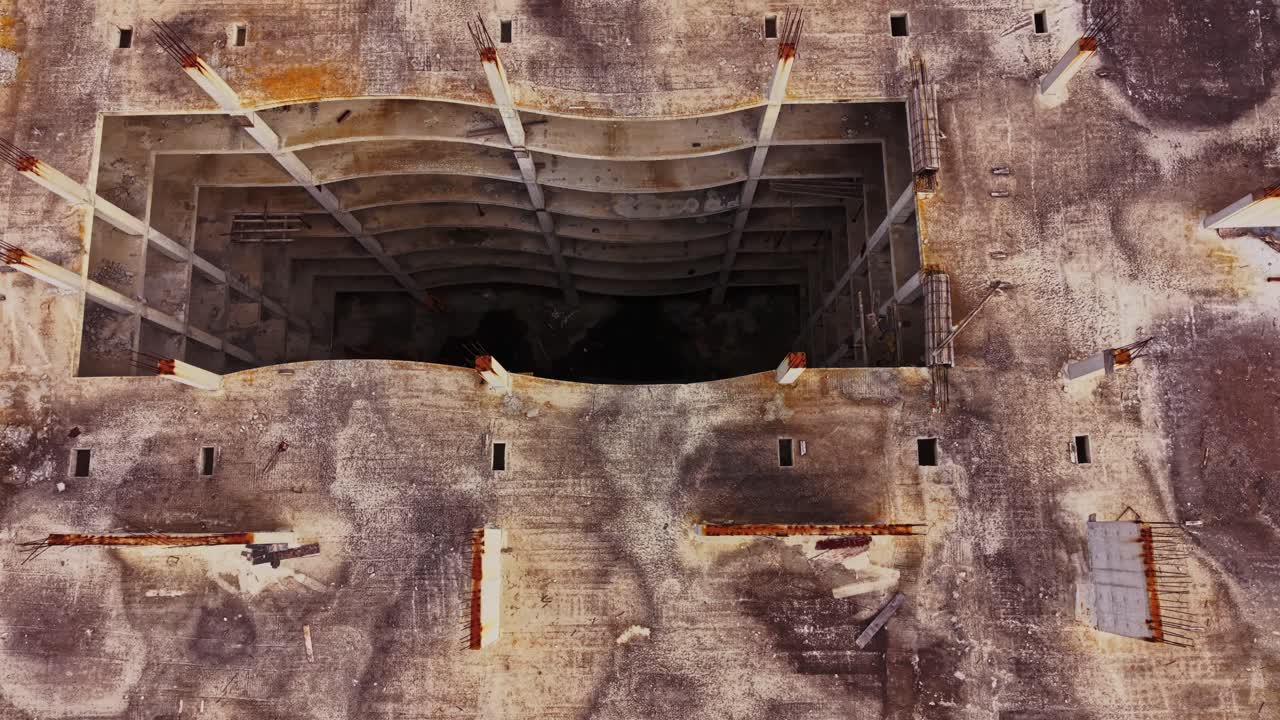 Aerial view of an abandoned building site with debris scattered below