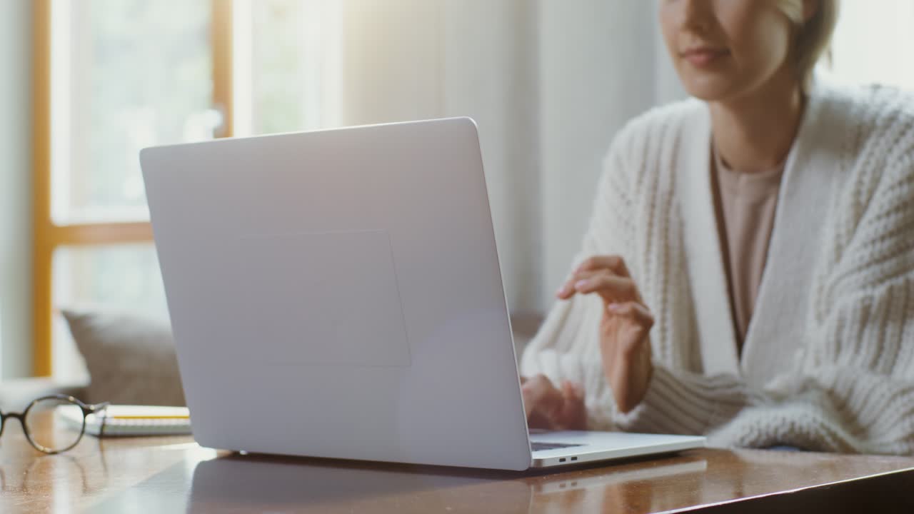 Woman Working on Laptop at Home