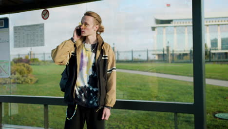 young man at bus stop