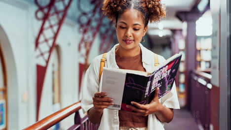 a student reading a textbook in a library