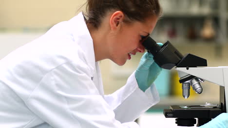 Pretty-science-student-looking-through-microscope