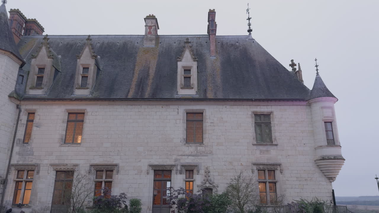 Historic Chaumont-sur-Loire castle with ivy and soft twilight lighting on a misty evening sky