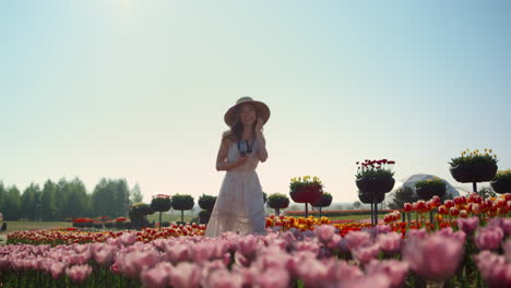 Beautiful-woman-laughing-in-spring-flower-garden.-Pretty-lady-walking-in-meadow.