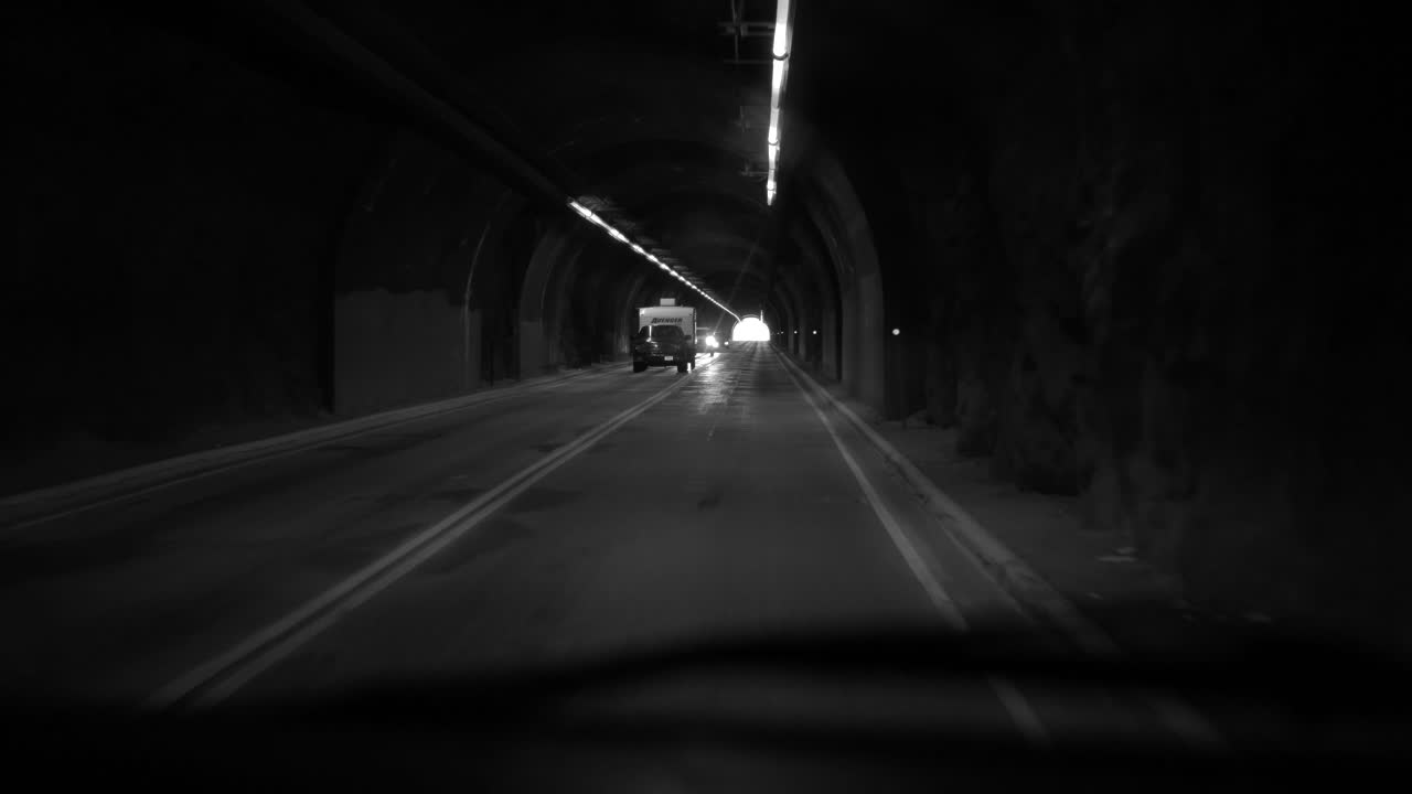 Gorgeous black and white clip of driving POV through a tunnel. Noir feel.