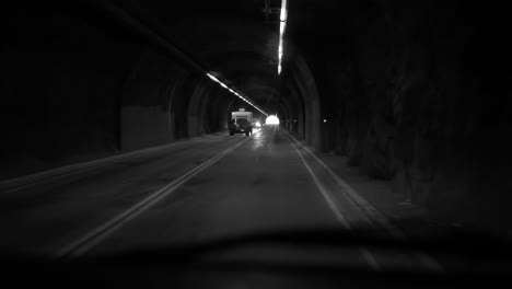 gorgeous black and white clip of driving pov through a tunnel. noir feel.