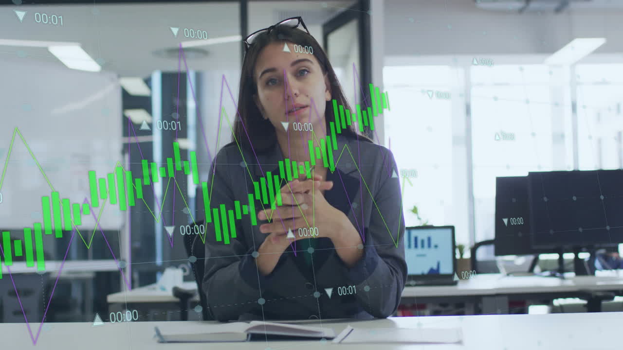 Businesswoman in office with financial graph animation overlaying her image