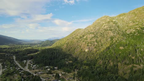 Pan-left-of-Andean-mountains-covered-in-a-beautiful-pine-tree-woodland-near-Lago-Puelo-valley-at-golden-hour,-Chubut,-Patagonia-Argentina