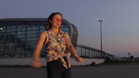 happy woman tourist dancing floss meme dance joyfully, celebrating success, enjoying music. sunset