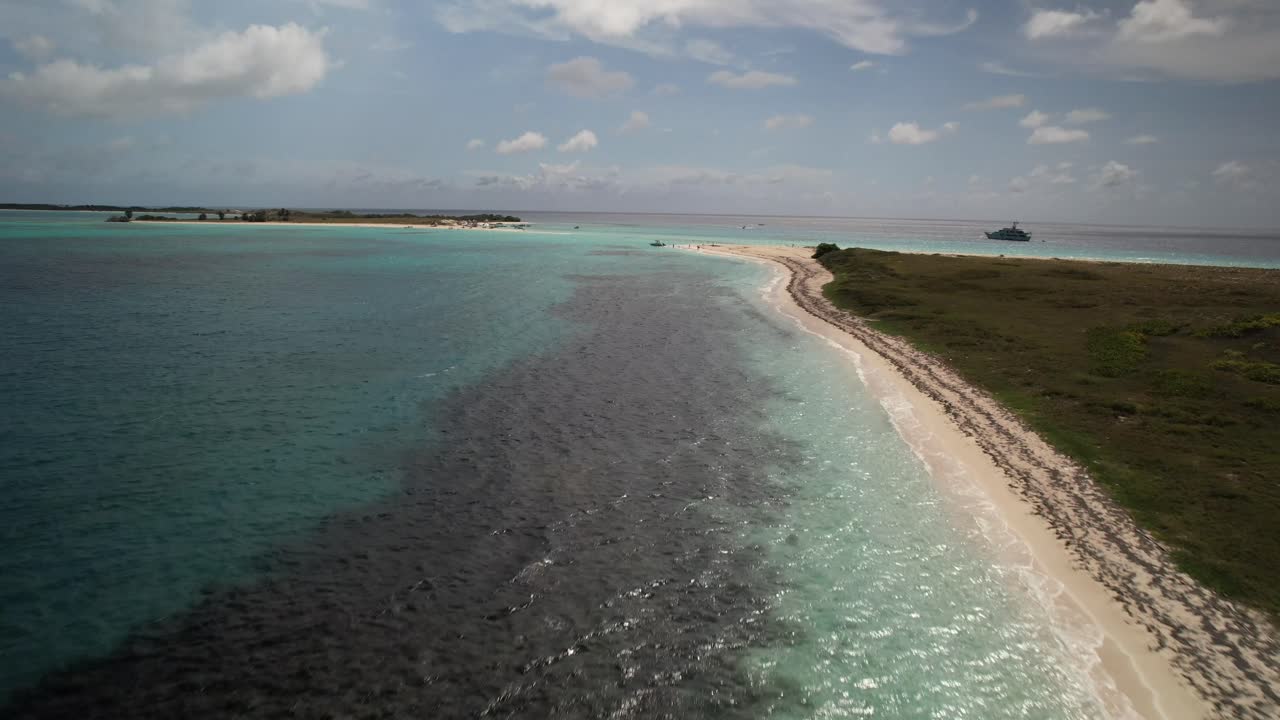 A tranquil aerial view of a tropical beach, turquoise waters, and vibrant coastline
