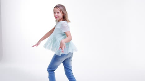 young girl walking and dancing across frame in slow motion