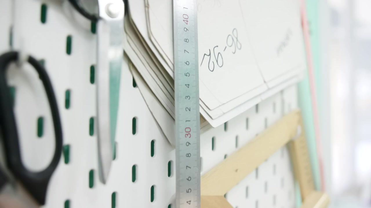 Closeup Pegboard With Rulers Scissors, Pattern Pieces Clipped, Metal Ruler Aligned, Pastel Board Background, . Media
