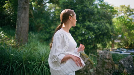 carefree woman enjoy walk at summer park close up. girl strolling green garden