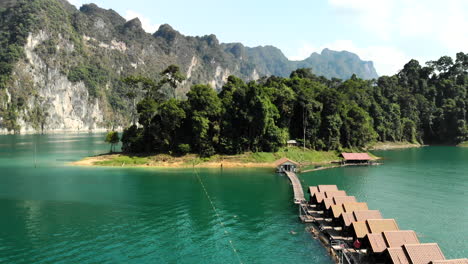 Drone-view-of-floating-hotel-rooms-in-a-lake-in-Kao-Sok-National-Park,-Thailand