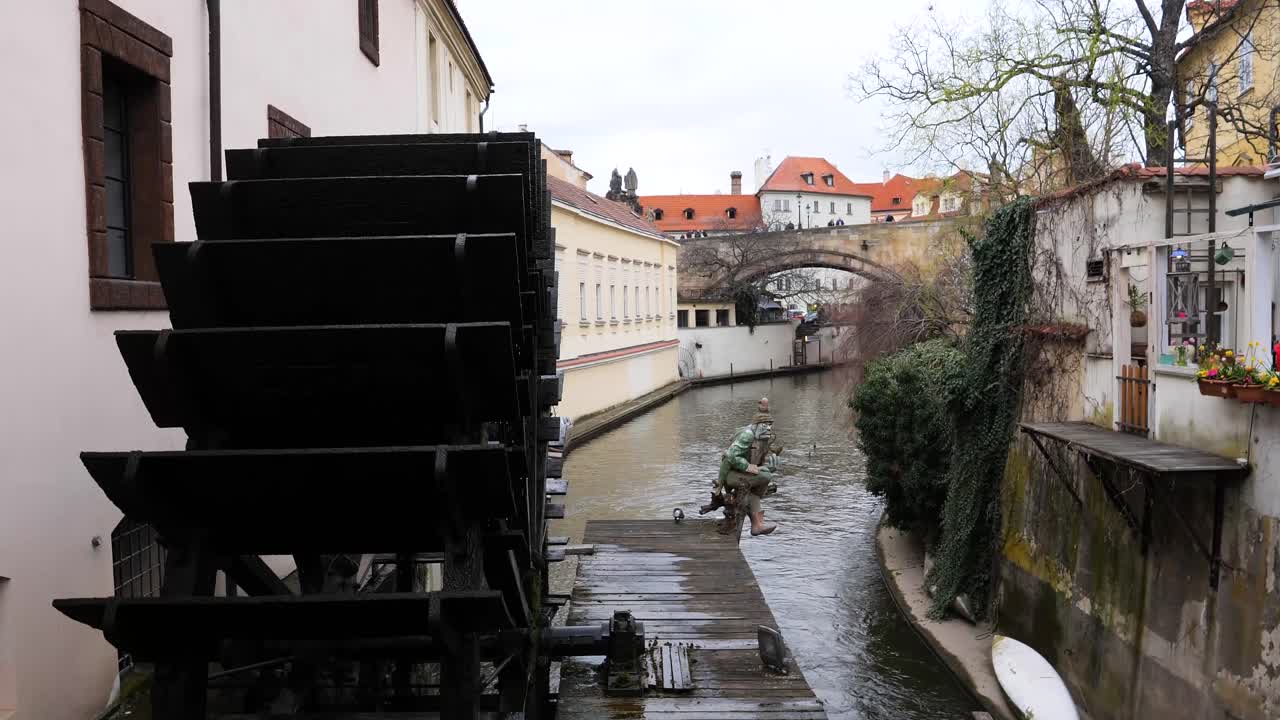 Houses along the Devil&acute;s Stream and the wooden wheel of Grand Priory Mill Prague, Czech Republic