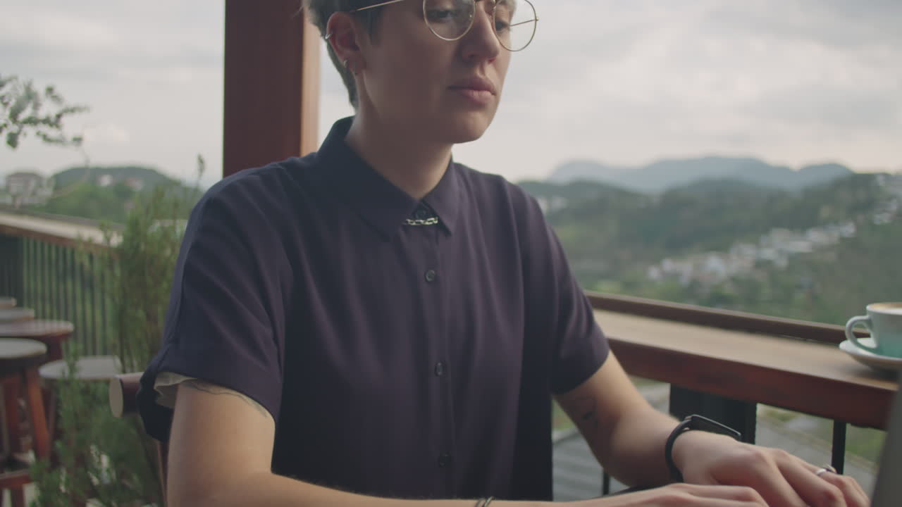 Young Woman Working Online in Cafe with Mountain View