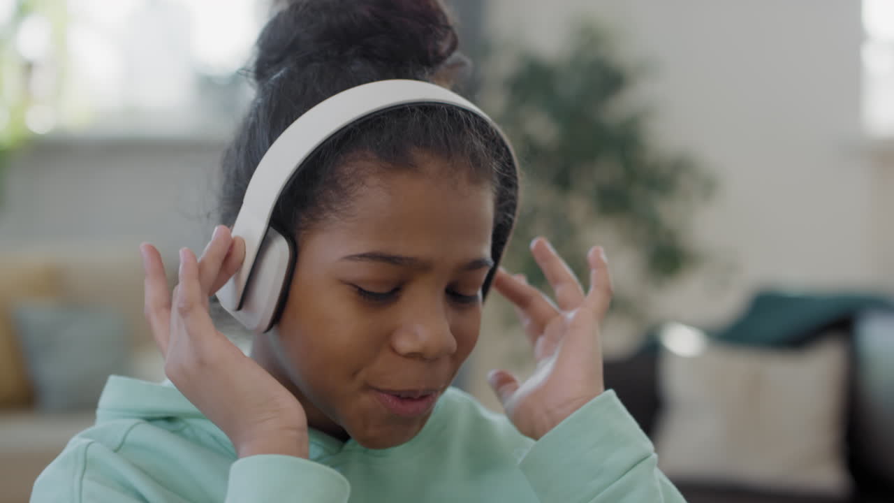Close Up Of Afro Girl Listening To Music