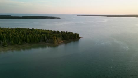 aerial daytime fly to forested peninsula, lake huron, michigan