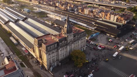 aerial view of traffic on road,driving buses in front of train station with historic building during sunset - rush hour time in retiro district of buenos aires,argentina