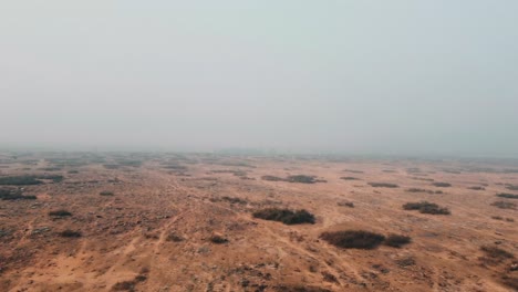 Aerial-Drone-shot-of-winter-fog-in-a-barrend-landscape-of-India