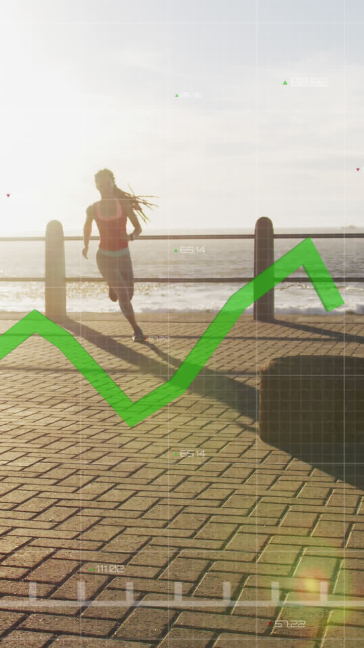gráfico verde moviéndose contra afroamericano mujer en forma corriendo en el paseo marítimo
