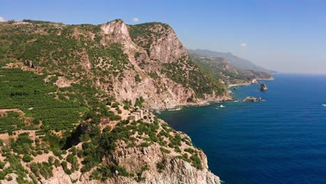 aerial shot of rocky shoreline of mediterranean sea on sunny day, turkey