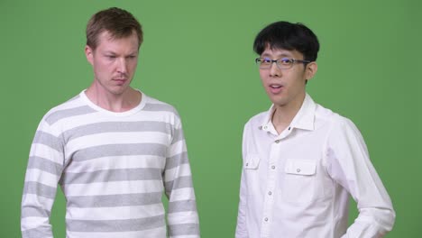 two young multi-ethnic businessmen confused with different decisions