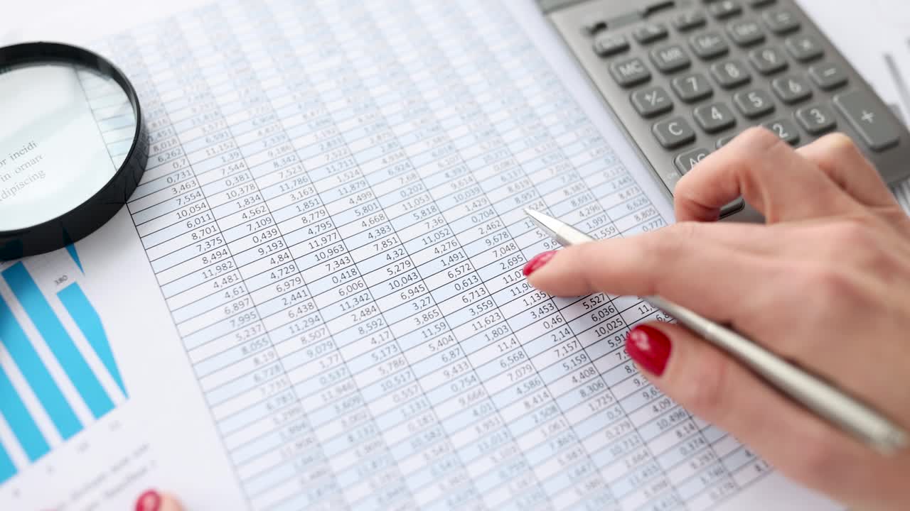 Woman studying numbers on document and counting on calculator 4k movie