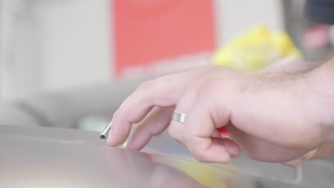 Process-of-Applying-Vinyl-Foil-on-Car,-Exterior-Wrapping-Close-Up-Hand