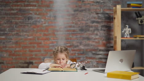 upset little girl with smoke above head tired of homework