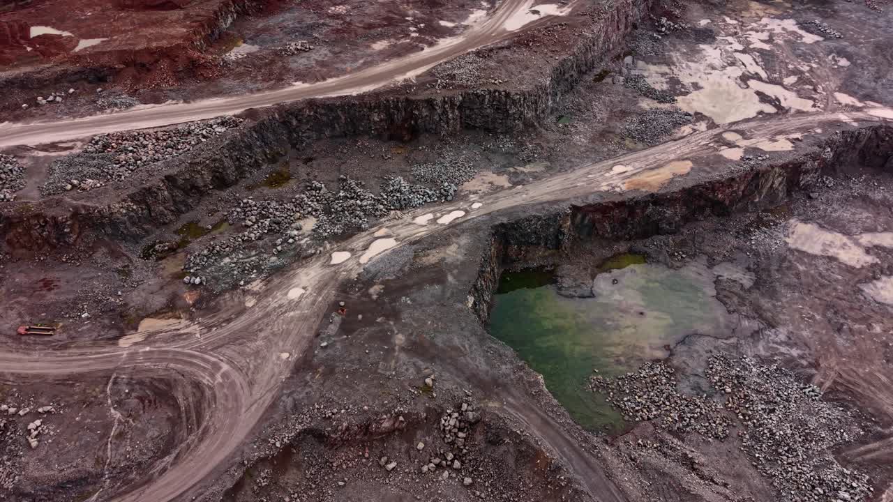 Workers are extracting granite in a large quarry
