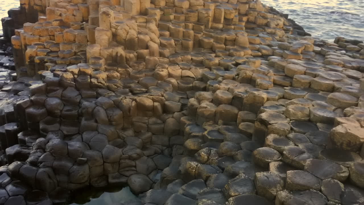 Smooth pan across the honey comb hexagonal steps at giants causeway
