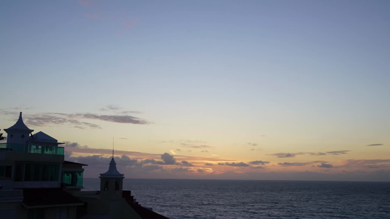 Cancun sunrise with a hotel in the foreground