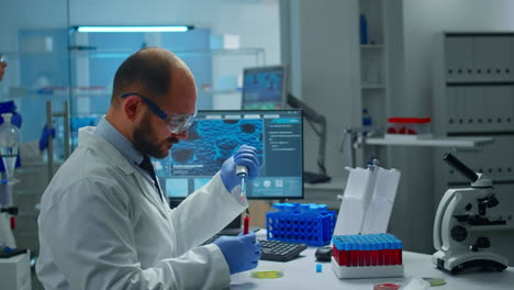 Scientist-examining-drug-discovery-putting-blood-sample-in-petri-dish-with-micropipette.