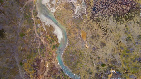 Top-down-drone-shot-flying-over-a-colorful-hiking-trail-in-Tierra-del-Fuego,-Argentina